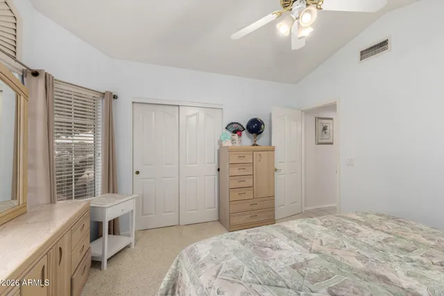 a spacious bedroom with a bed and a window