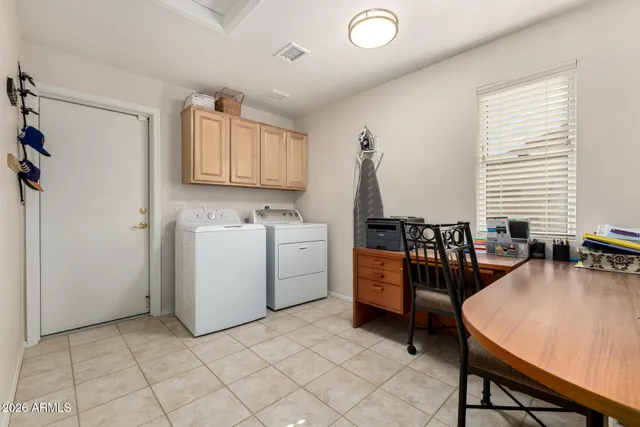 a view of a workspace with furniture and a window