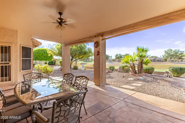 a view of a porch with furniture and a yard