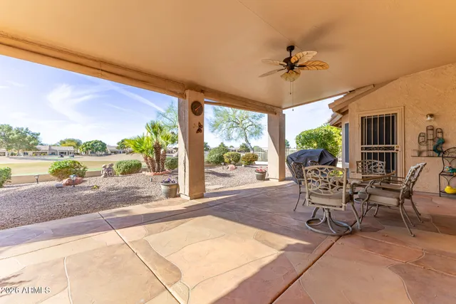 a patio with yard glass top table and chairs