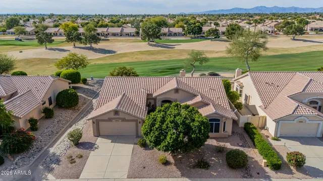 an aerial view of a house with garden space and ocean view