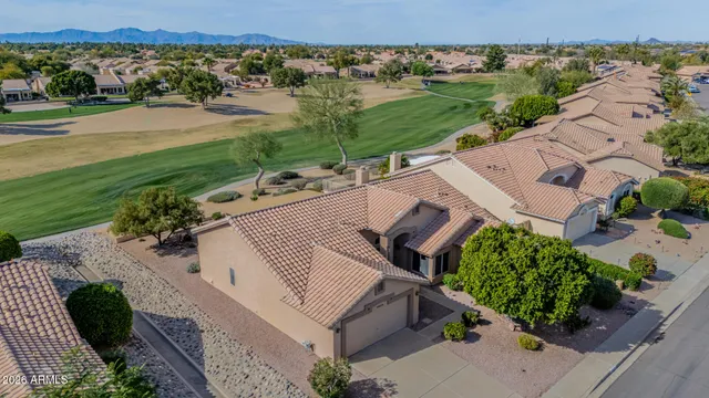 an aerial view of a house with a yard
