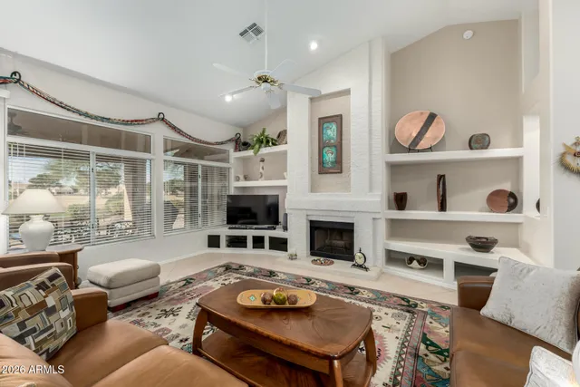 a living room with furniture fireplace and flat screen tv