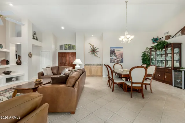 a living room with furniture and a chandelier