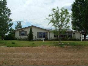 1115 Saddle Road Paulden, AZ 86334 - Photo 3 of 10 a house that is sitting in middle of forest
