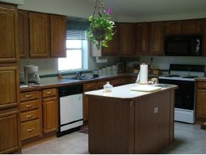 1115 Saddle Road Paulden, AZ 86334 - Photo 8 of 10 a kitchen with a sink dishwasher a stove a microwave and cabinets