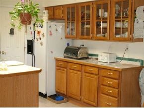 1115 Saddle Road Paulden, AZ 86334 - Photo 9 of 10 a kitchen with stainless steel appliances granite countertop a refrigerator a sink dishwasher and white cabinets with wooden floor