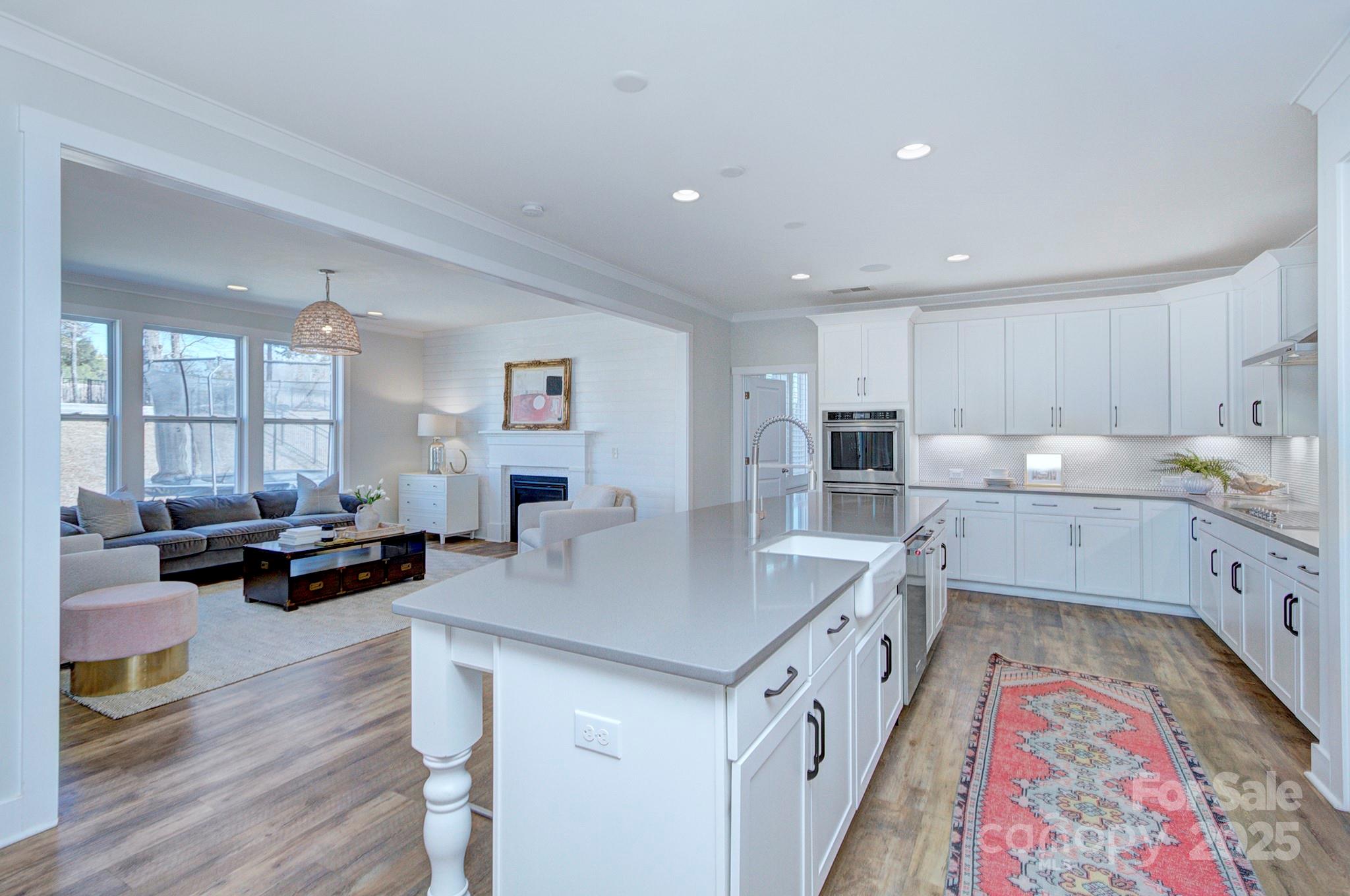 1176 Weir Court Fort Mill, SC 29708 - Photo 11 of 35 a open kitchen with sink cabinets and wooden floor