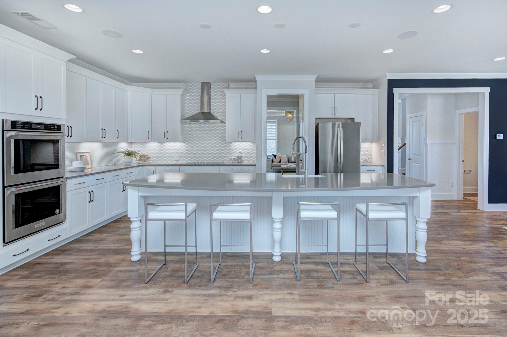1176 Weir Court Fort Mill, SC 29708 - Photo 12 of 35 a kitchen with stainless steel appliances granite countertop a stove a sink and white cabinets