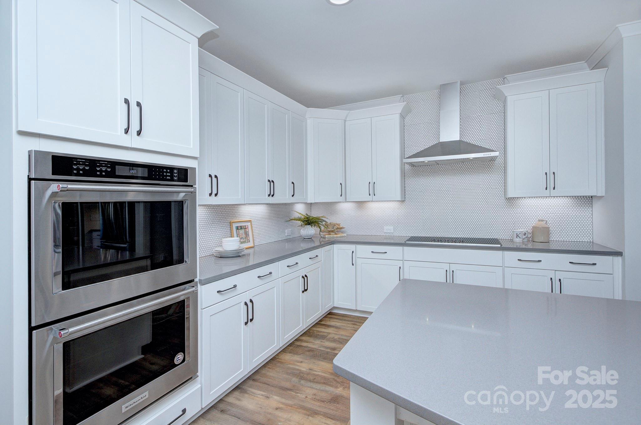 1176 Weir Court Fort Mill, SC 29708 - Photo 13 of 35 a kitchen with granite countertop white cabinets stainless steel appliances and sink