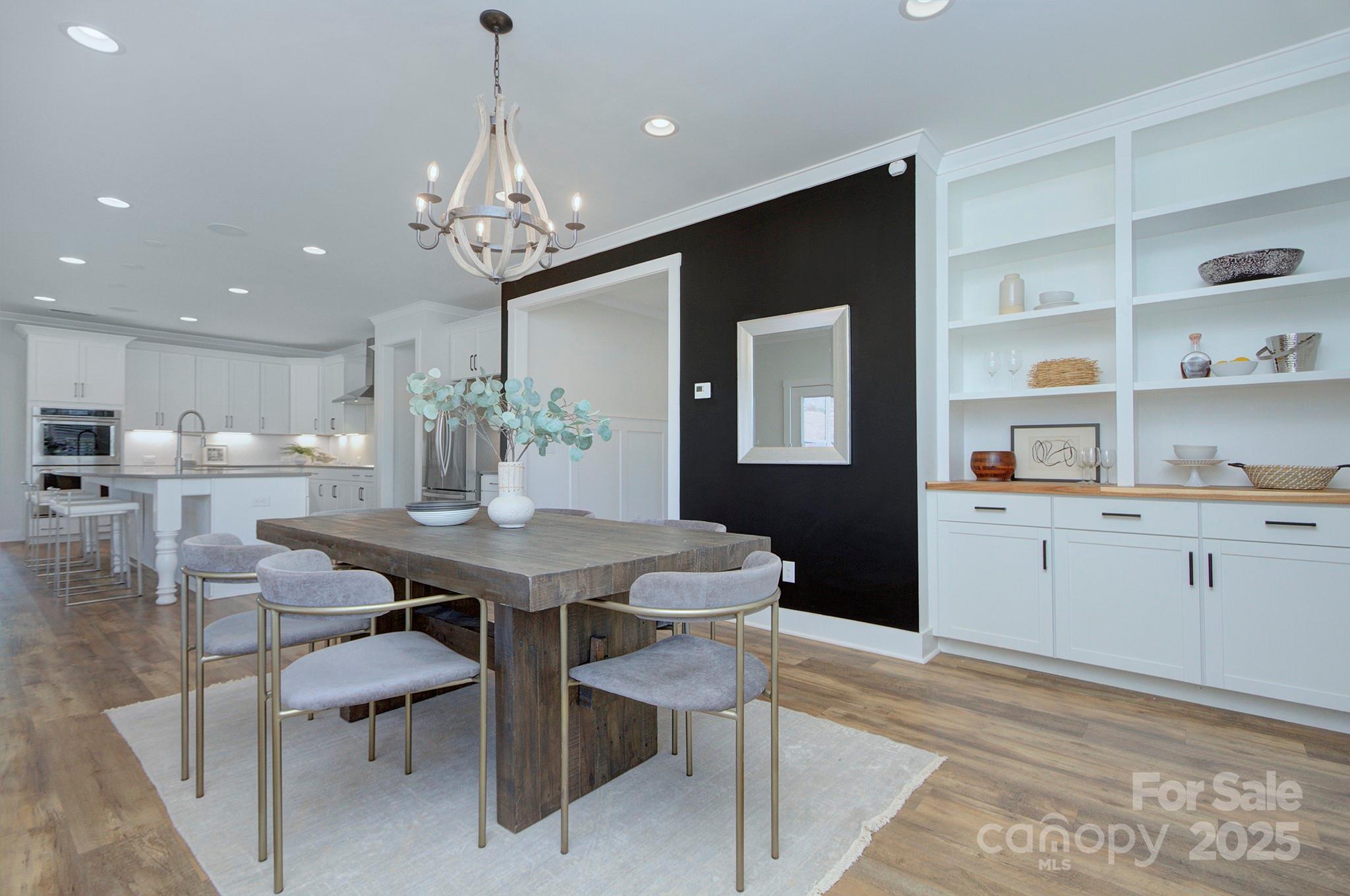 1176 Weir Court Fort Mill, SC 29708 - Photo 15 of 35 a kitchen with a dining table chairs cabinets and stainless steel appliances