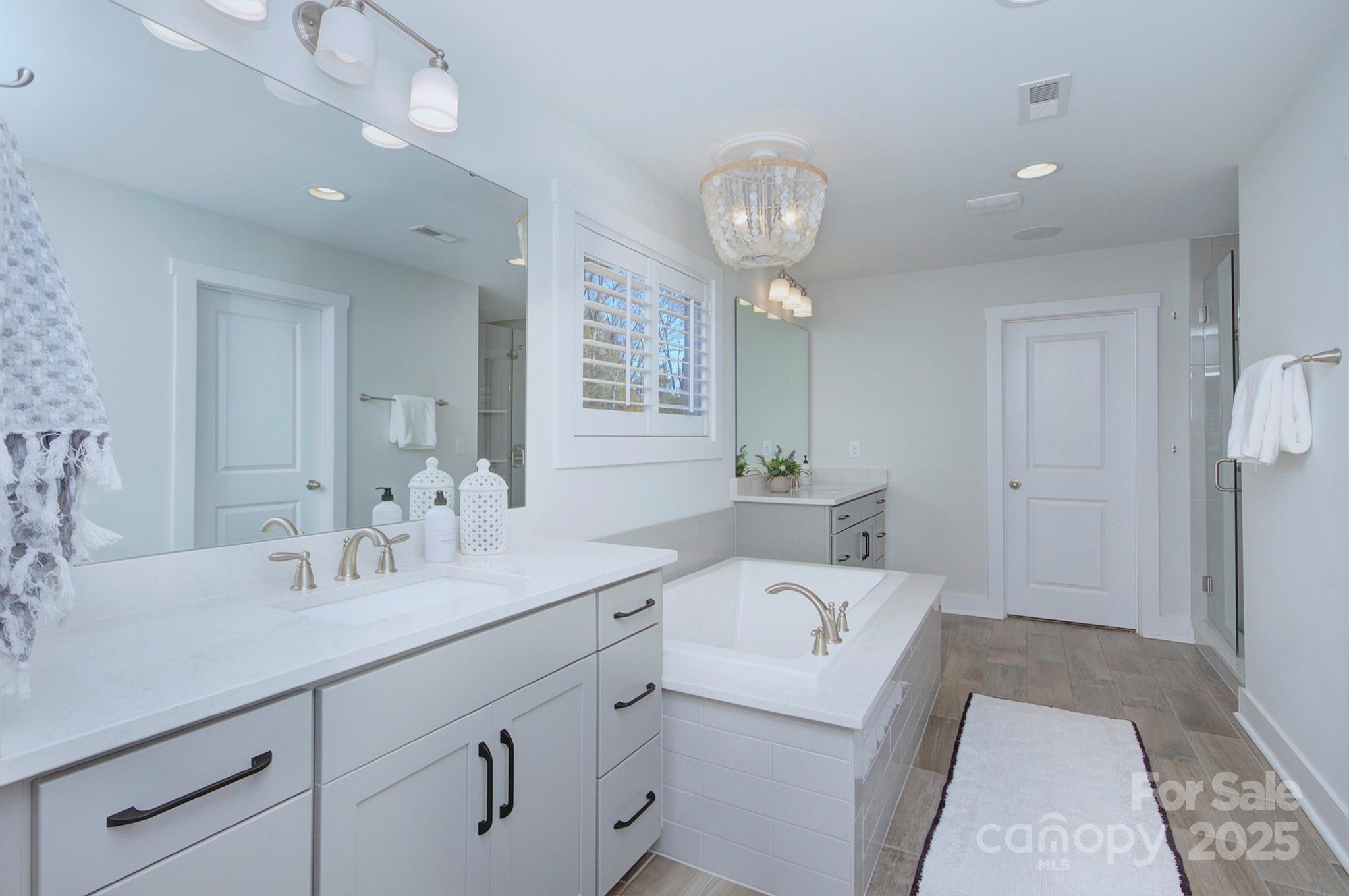 1176 Weir Court Fort Mill, SC 29708 - Photo 22 of 35 a en suite bathroom with a double vanity sink and a mirror