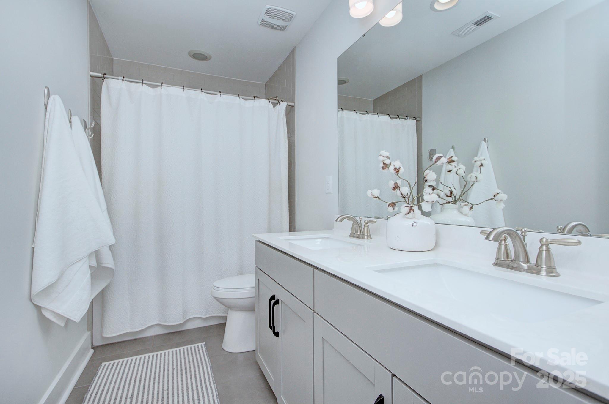 1176 Weir Court Fort Mill, SC 29708 - Photo 24 of 35 a bathroom with a sink a toilet and shower curtain