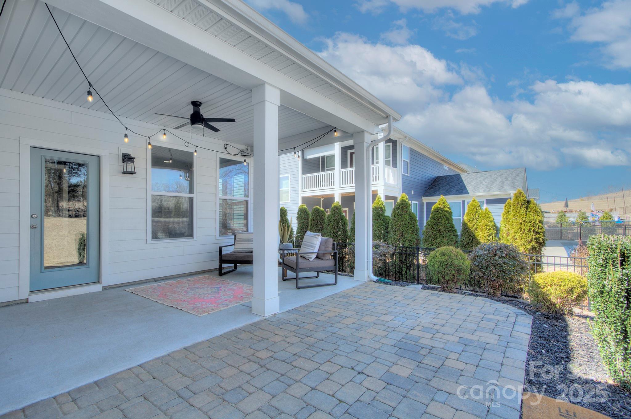 1176 Weir Court Fort Mill, SC 29708 - Photo 26 of 35 a view of a brick house with a large windows and plants