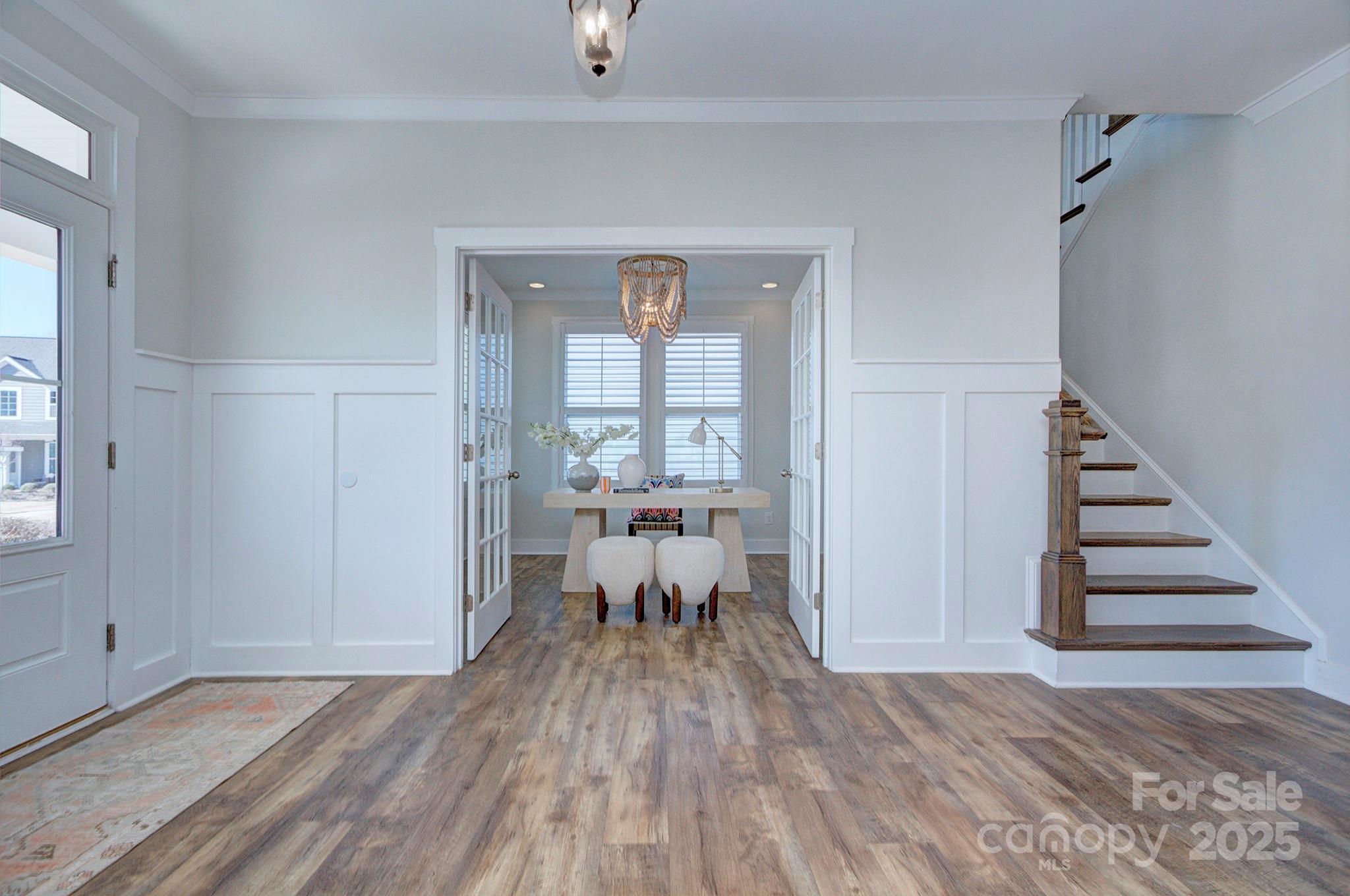 1176 Weir Court Fort Mill, SC 29708 - Photo 3 of 35 a view of a room with wooden floor lounge chair and windows