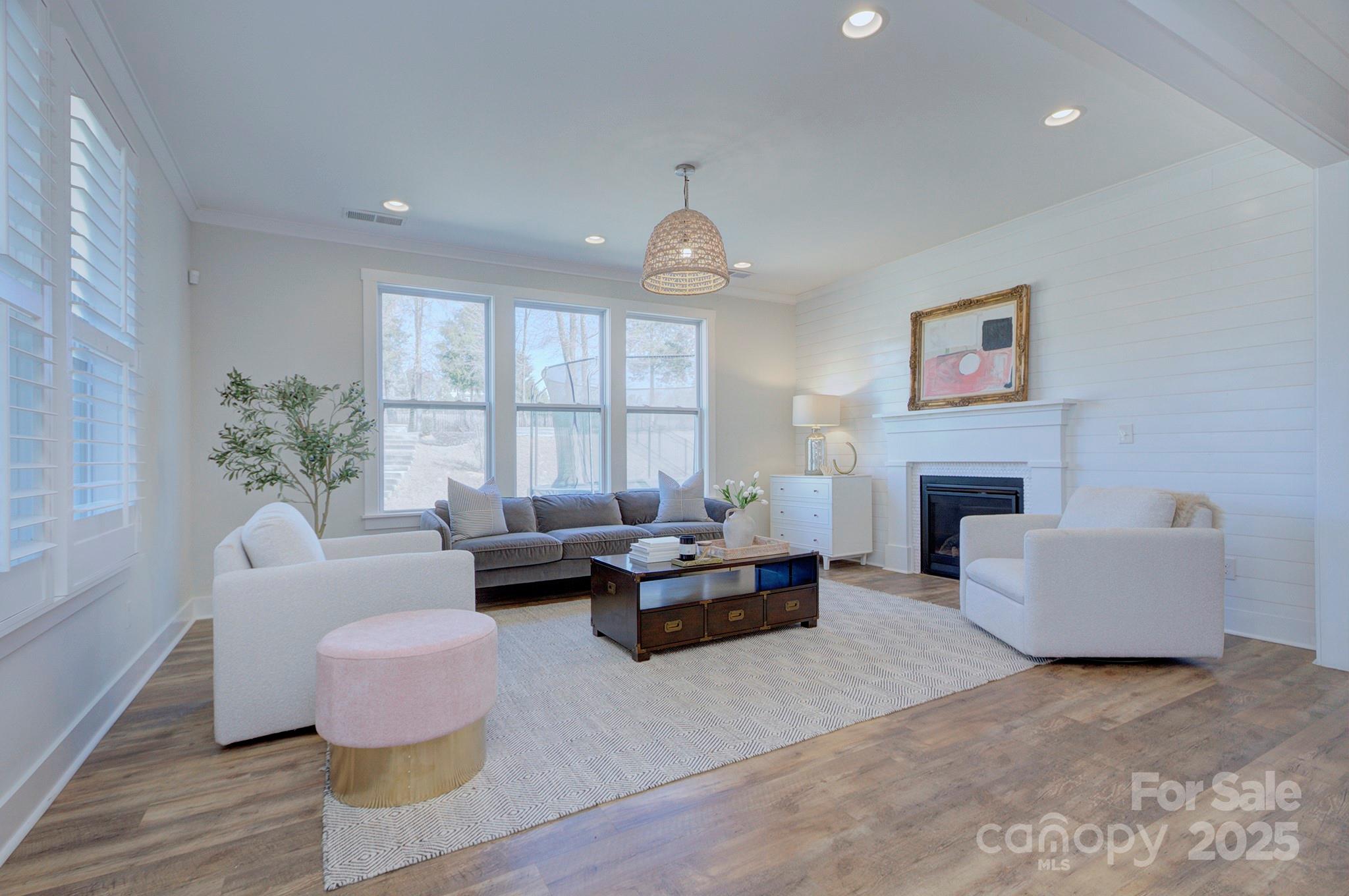 1176 Weir Court Fort Mill, SC 29708 - Photo 9 of 35 a living room with furniture a fireplace and a large window
