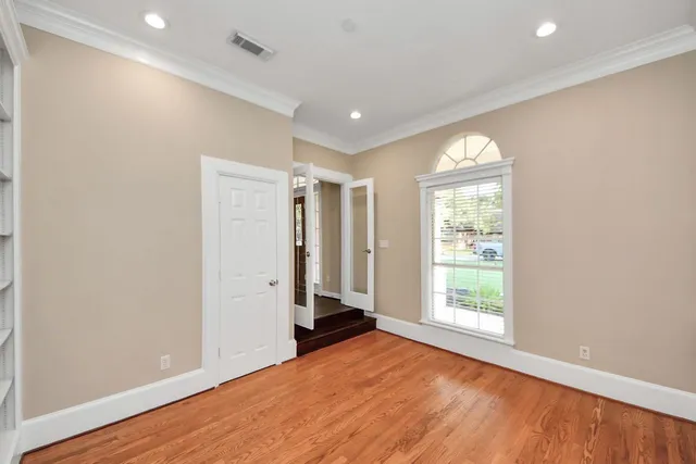 a living room with furniture fireplace and a large window