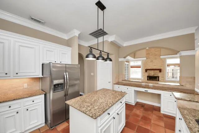 a spacious bathroom with a granite countertop double vanity and a mirror