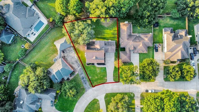 an aerial view of a house with garden space and street view
