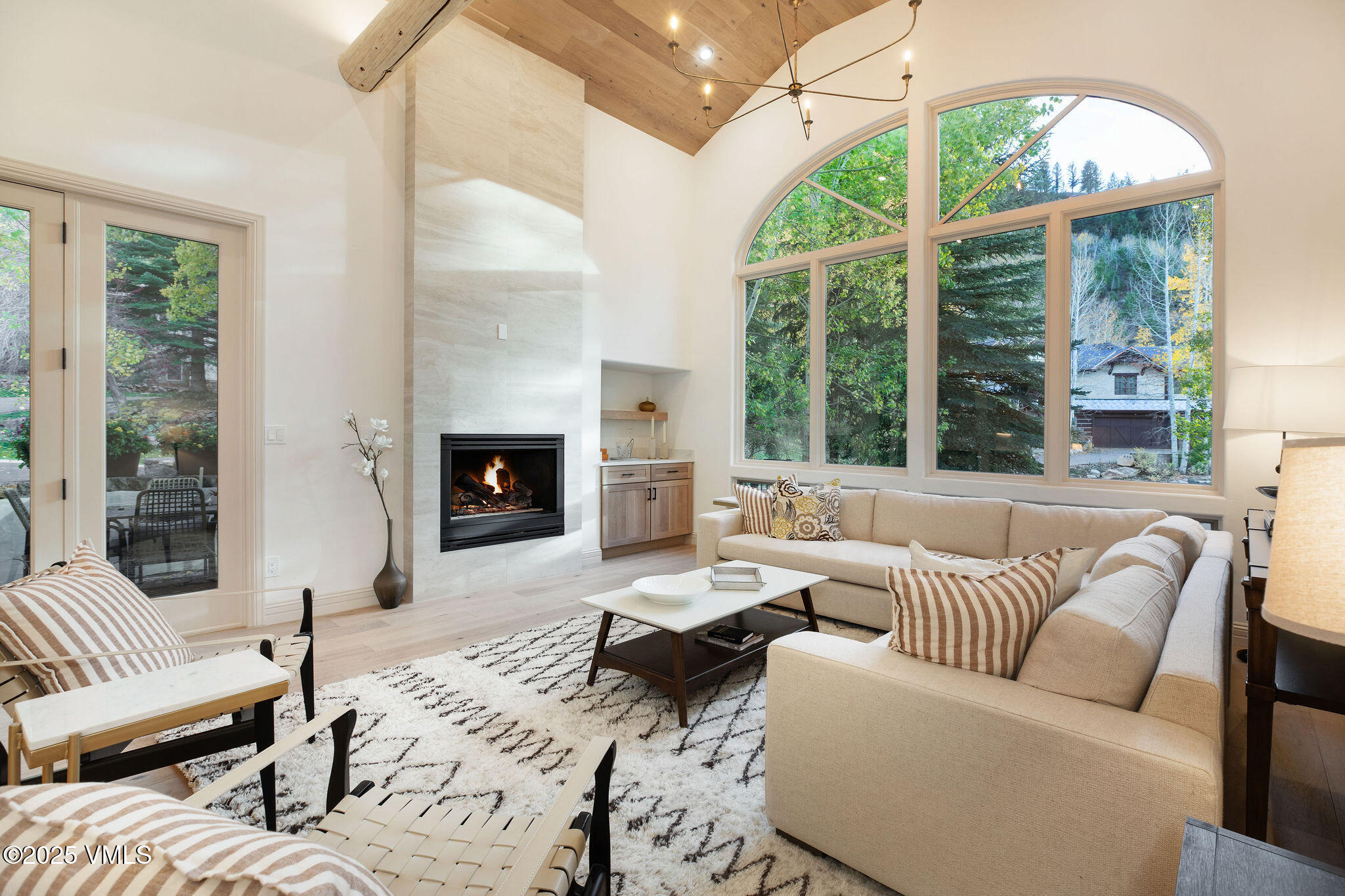 230 Castle Peak Gate, Unit B Edwards, CO 81632 - Photo 1 of 12 a living room with furniture fireplace and large windows