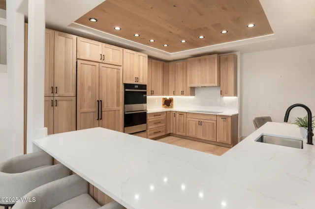 a kitchen with stainless steel appliances a refrigerator sink and cabinets