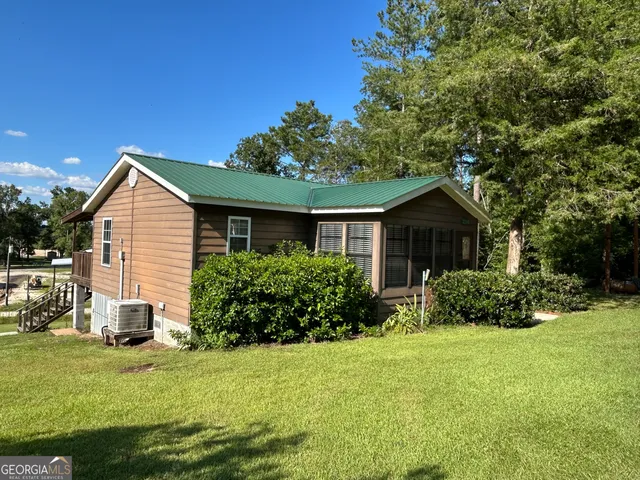 a front view of house with yard and green space