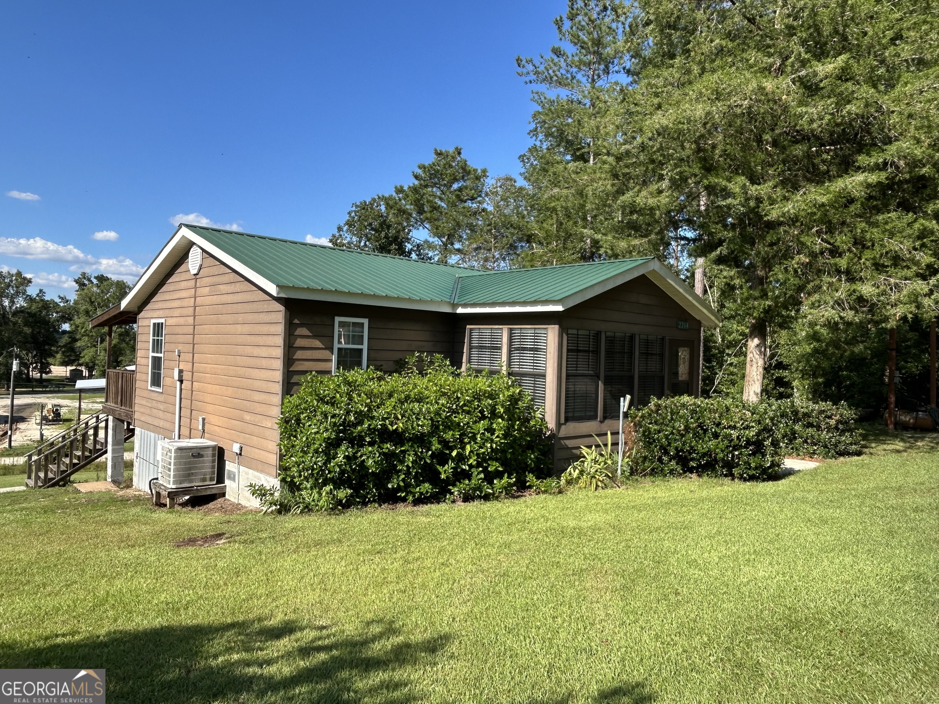 a front view of house with yard and green space