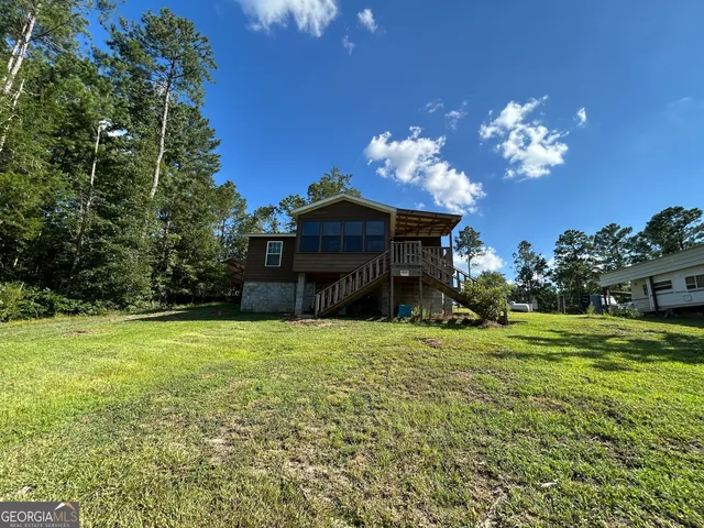 a house with a big yard and large trees