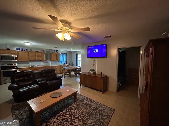 a living room with furniture and a flat screen tv