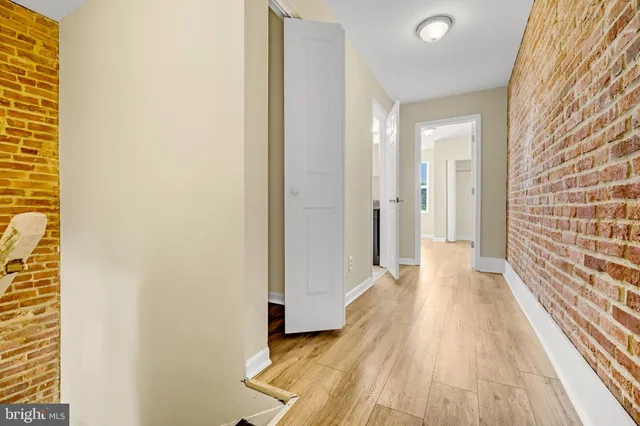 a view of a hallway with wooden floor