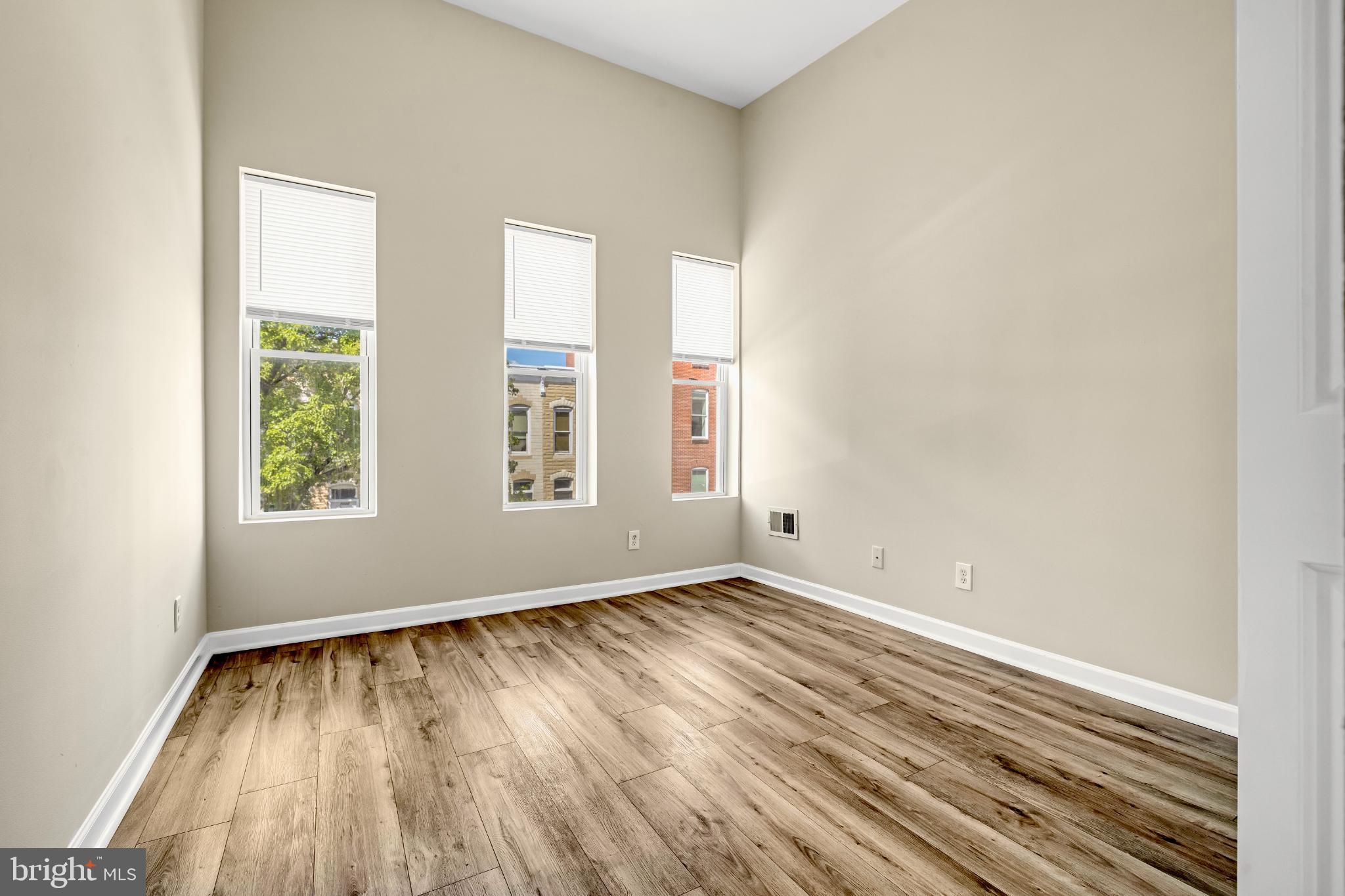 2131 Jefferson Street Baltimore, MD 21205 - Photo 13 of 24 an empty room with wooden floor and windows