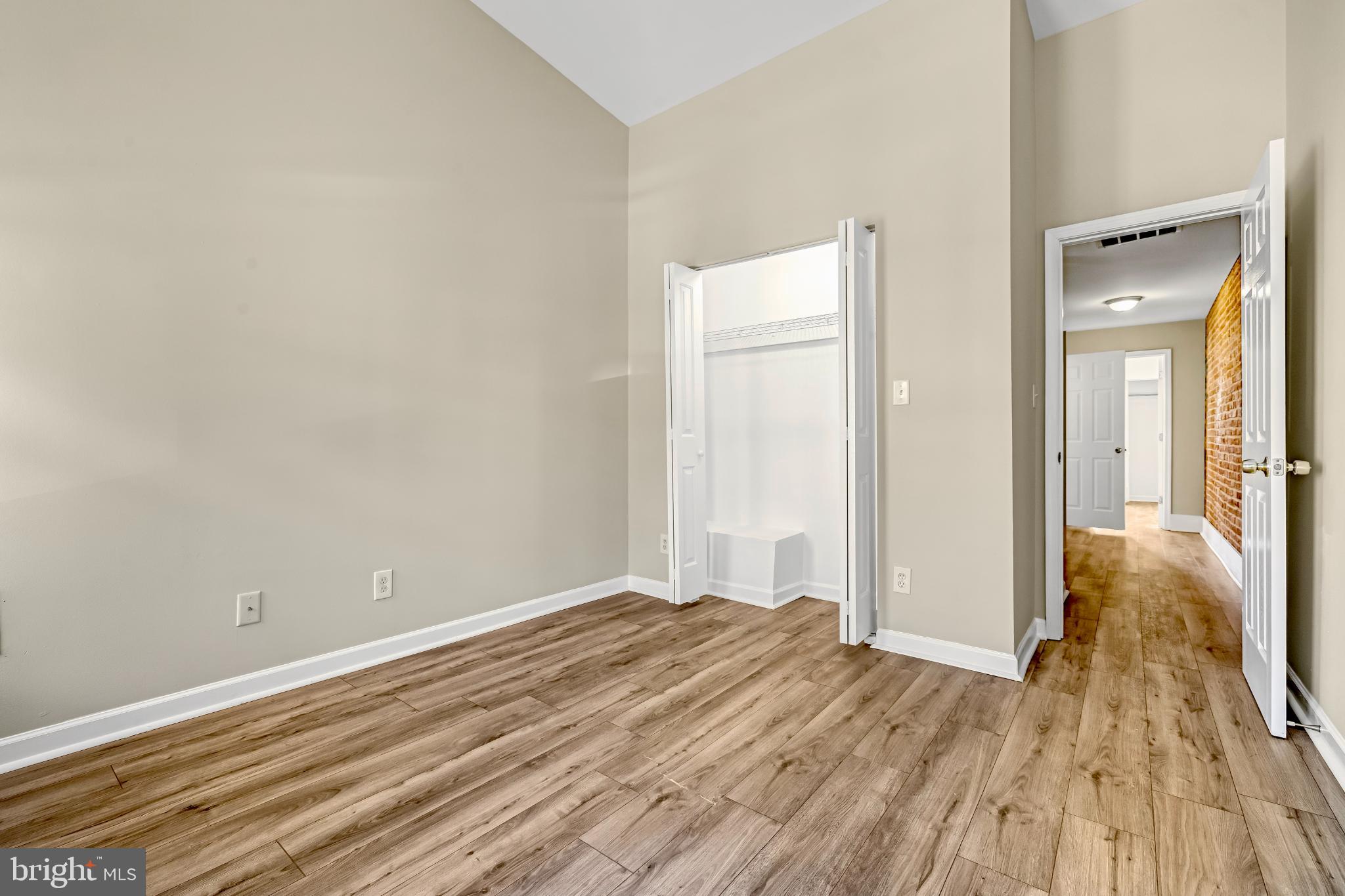 2131 Jefferson Street Baltimore, MD 21205 - Photo 14 of 24 a view of a room with wooden floor and a bathroom