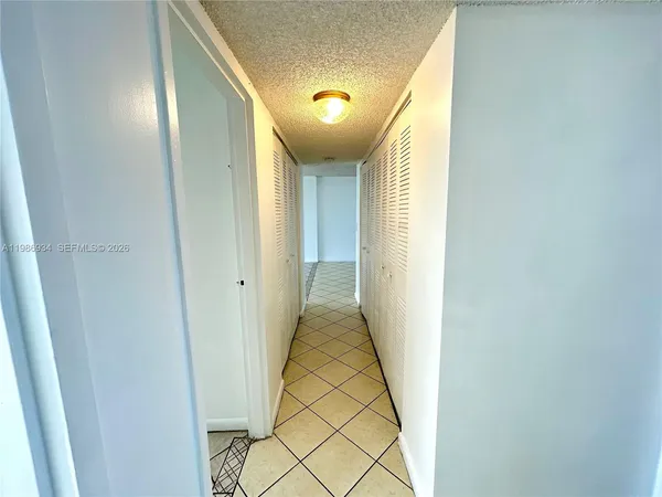 a view of a room with wooden floor and iron stairs