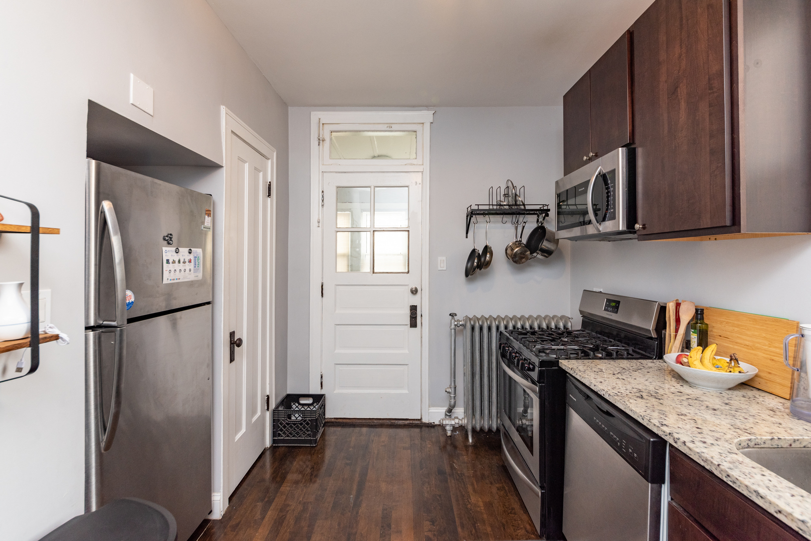 4014 West Nelson Street, Unit 1 Chicago, IL 60641 - Photo 8 of 21 a kitchen with a refrigerator and a stove top oven