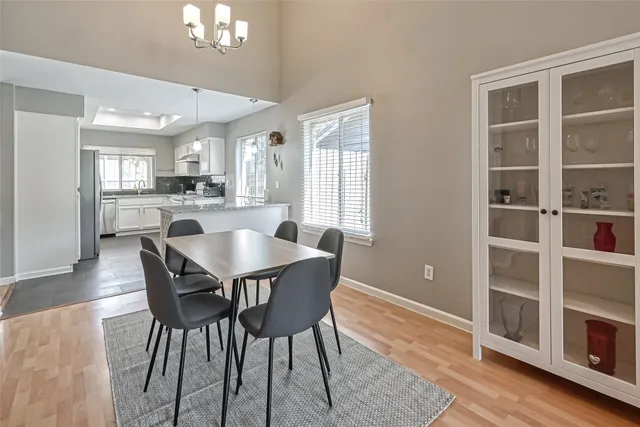 a dining room with furniture a window and wooden floor