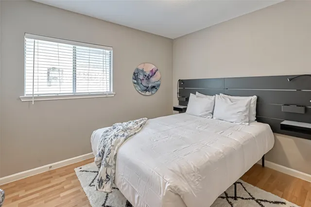 a bedroom with two beds and a window