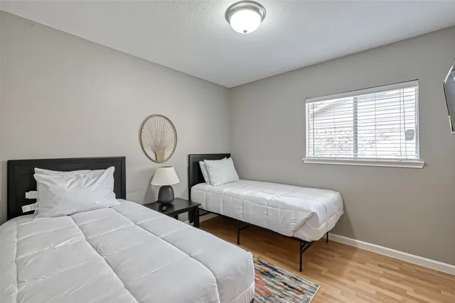 a bedroom with a bed and a night stand