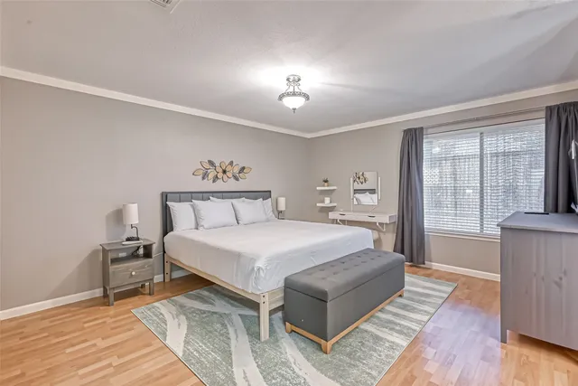 a spacious bedroom with a bed and a window