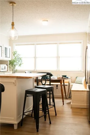 a dining table with chairs and window