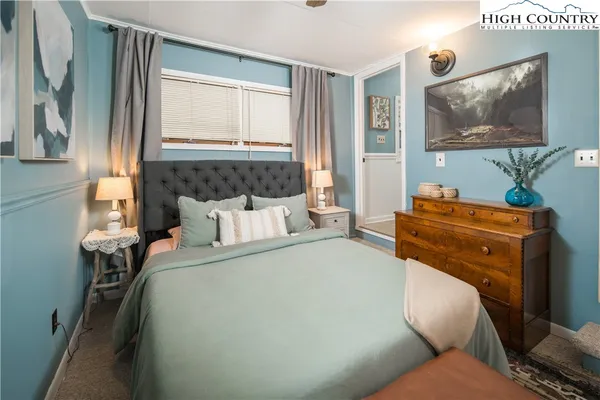 a bed room with a bed and a television