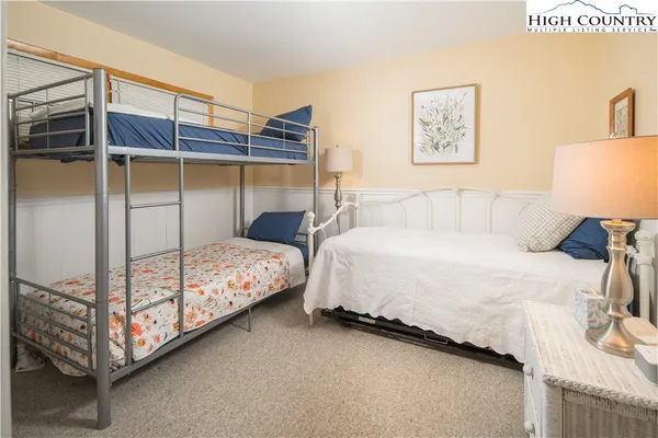 a bedroom with a bed and a night stand