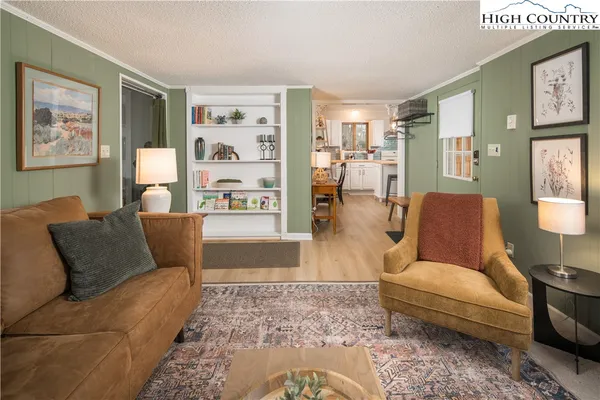 a living room with furniture and painting on the wall