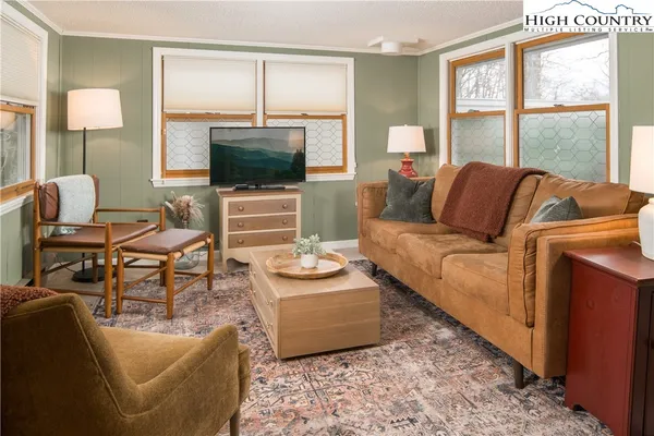 a living room with furniture and a flat screen tv