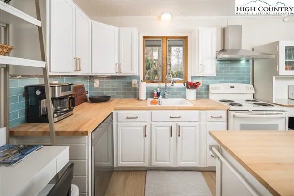 a kitchen with a sink stove and cabinets