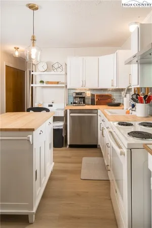 a kitchen with a stove oven and white cabinets