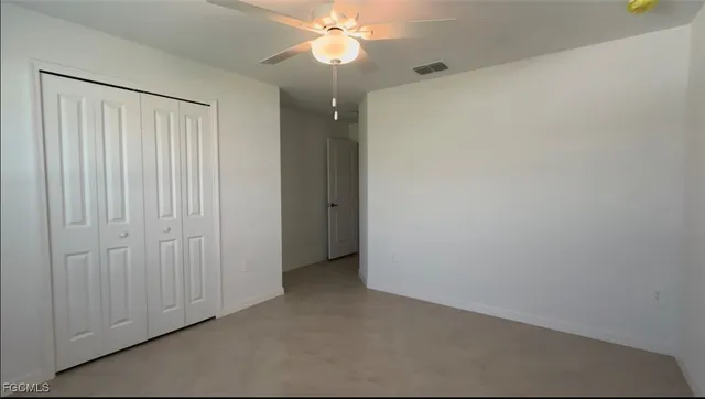 a view of a chandelier fan and entryway