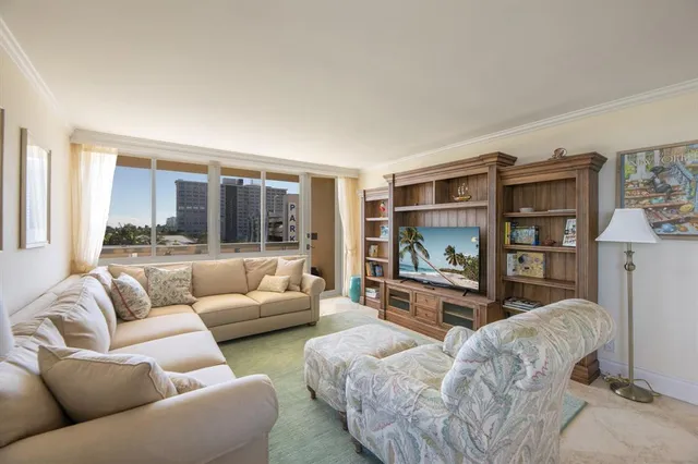 a dining room with furniture a chandelier and window