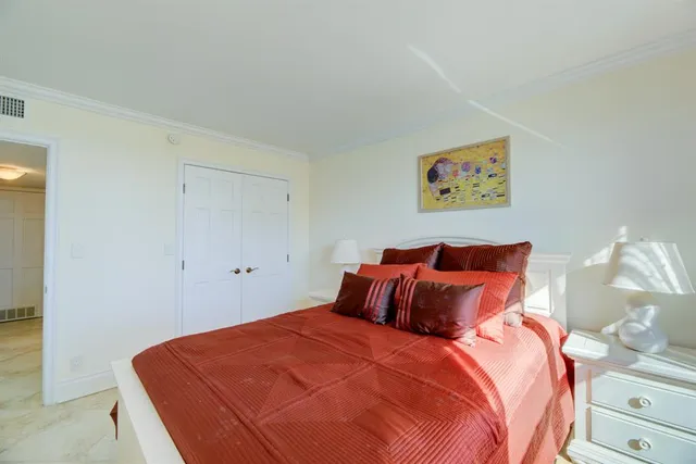 a bedroom with a bed and a closet