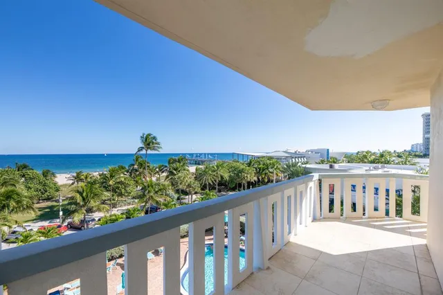 a view of a balcony with wooden fence