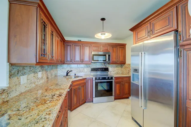 a view of a dining room with furniture and a chandelier